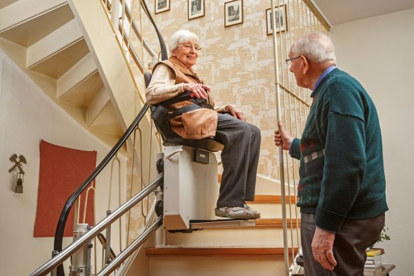 Elderly,Couple,In,The,Staircase,With,Stairlift